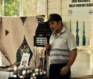 SFAC 2023 Albums. Image of Dr. Cooper speaking in front of golf fundraiser.