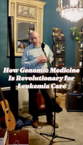 image of man in blue shirt and brown pants speaking at mic