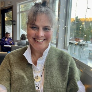 image of woman in green sweater vest