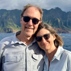 Image of man and woman with Hawaiian island in the background.