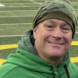 image of man in green beanie with green hoodie on.